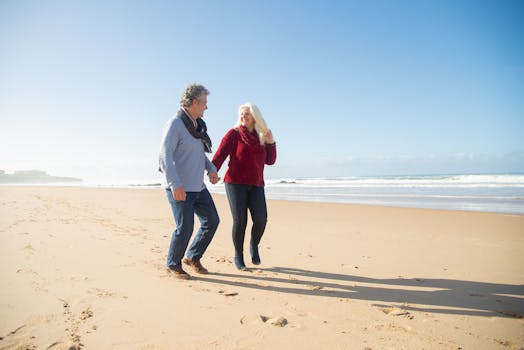 Happy retired couple walking on the beach